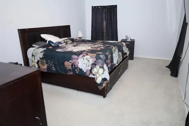 a bed sitting in a bedroom next to a window