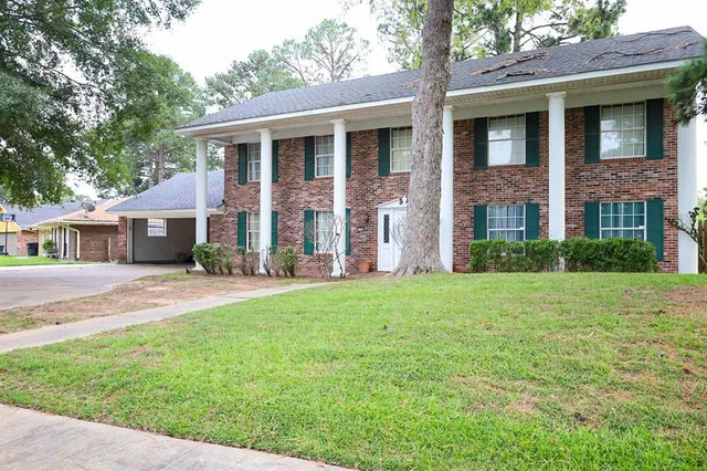 a front view of a house with a yard and a garage