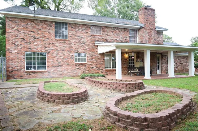 a view of a backyard with a tub and plants