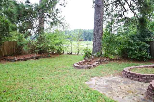 a view of a backyard with plants and outdoor seating