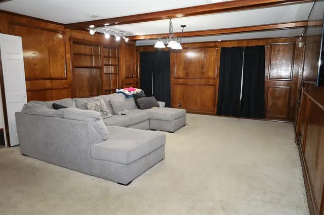 a living room with furniture and a glass door