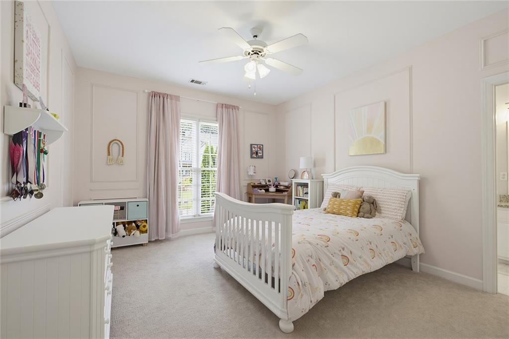 14442 Club Circle Milton, GA 30004 - Photo 38 of 82 a bedroom with a bed and a chandelier