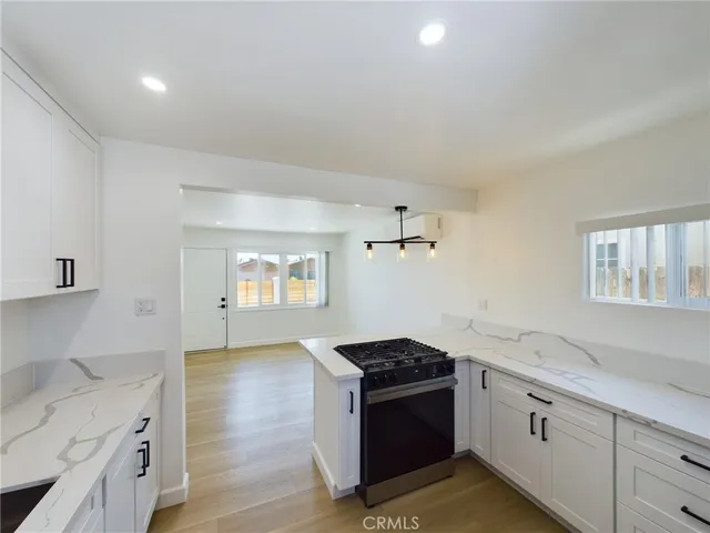 a kitchen with granite countertop a sink and a stove top oven
