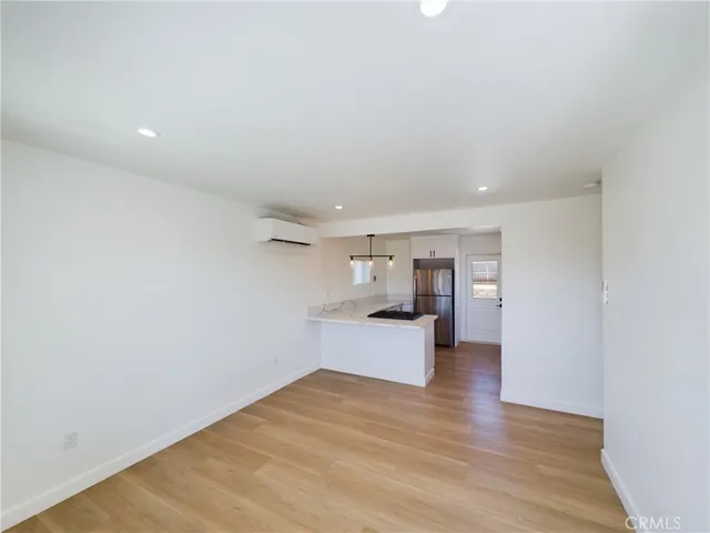 a view of a kitchen with wooden floor