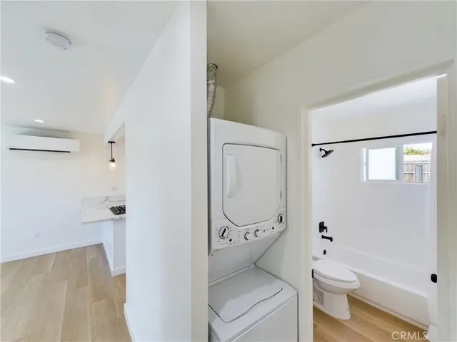 a bathroom with a granite countertop toilet a sink and a mirror