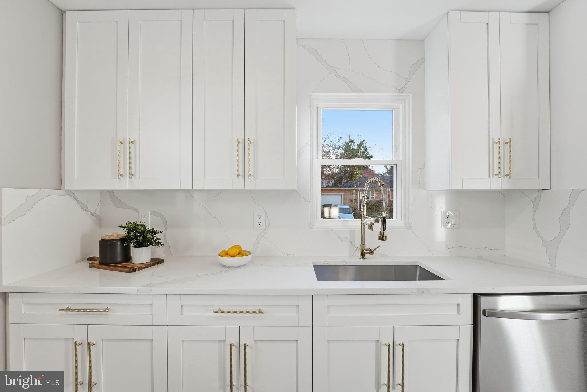 5716 Somerset Road Riverdale, MD 20737 - Photo 5 of 24 a kitchen with white cabinets and sink