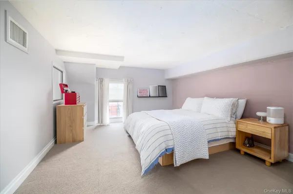 a bedroom with a bed and a couch