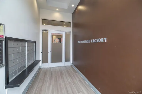 a view of hallway with wooden floor