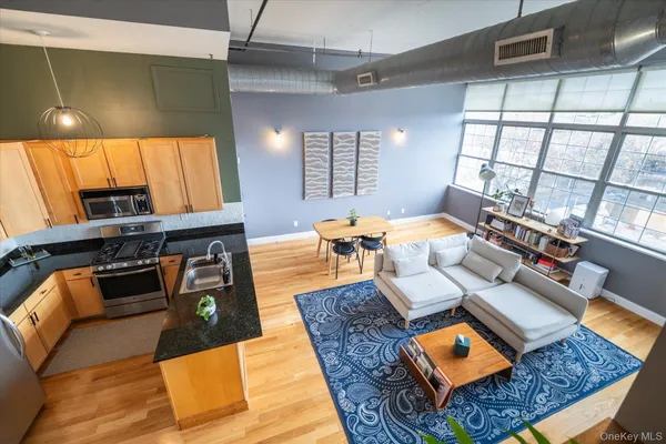 a living room with furniture and a floor to ceiling window