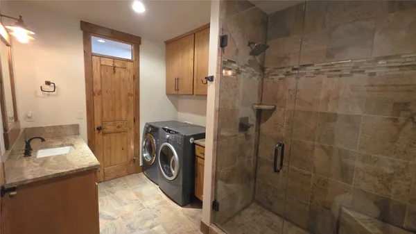 a bathroom with a sink a toilet and shower