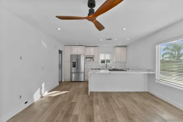 a view of a kitchen with wooden floor