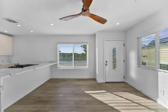 a view of a kitchen with a sink and dishwasher wooden floor