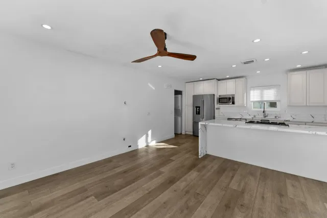 a view of kitchen with wooden floor