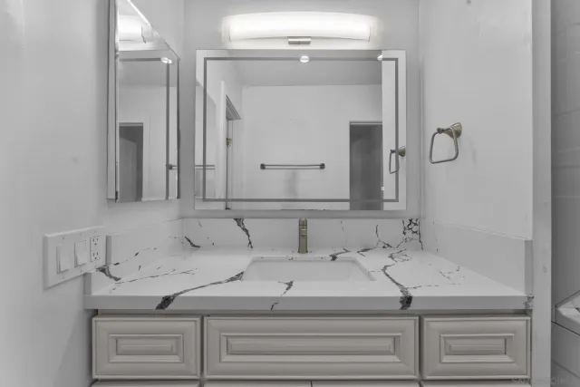 a bathroom with a sink and vanity
