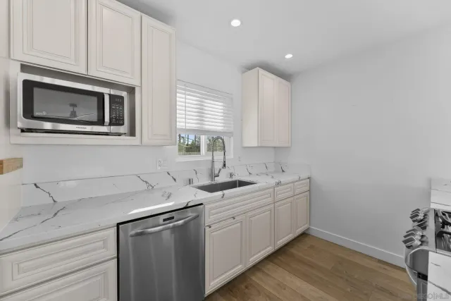 a kitchen with a sink stove and microwave
