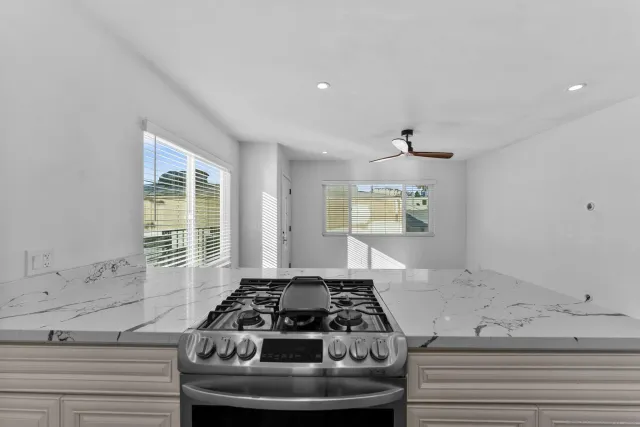 a kitchen with a stove and a window