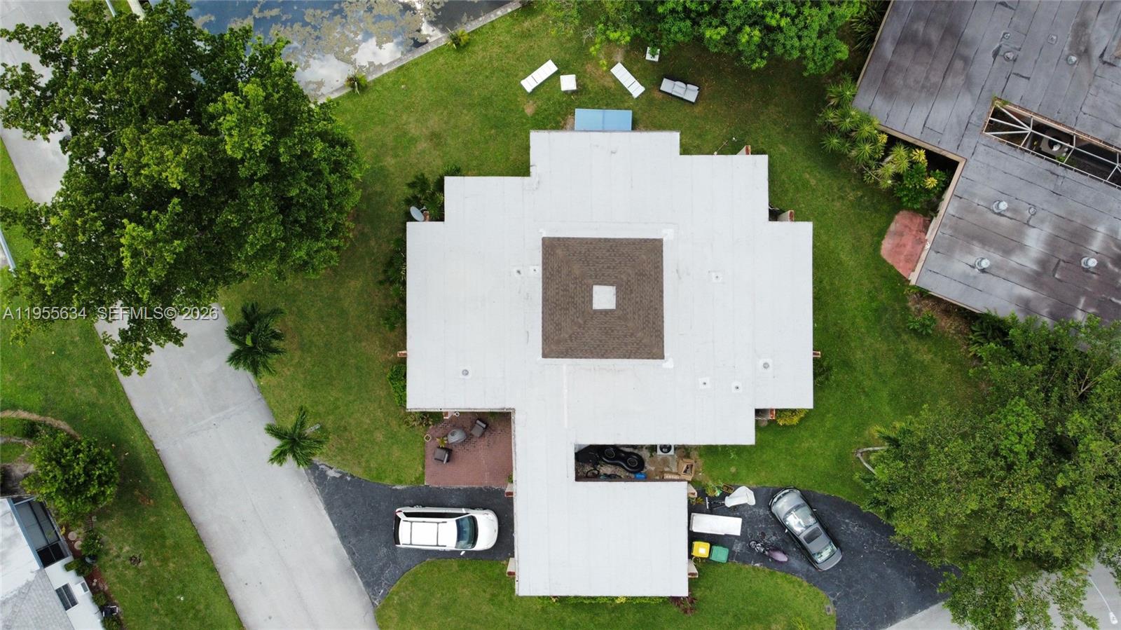 5700 White Hickory Circle Tamarac, FL 33319 - Photo 11 of 18 an aerial view of a house with swimming pool and garden