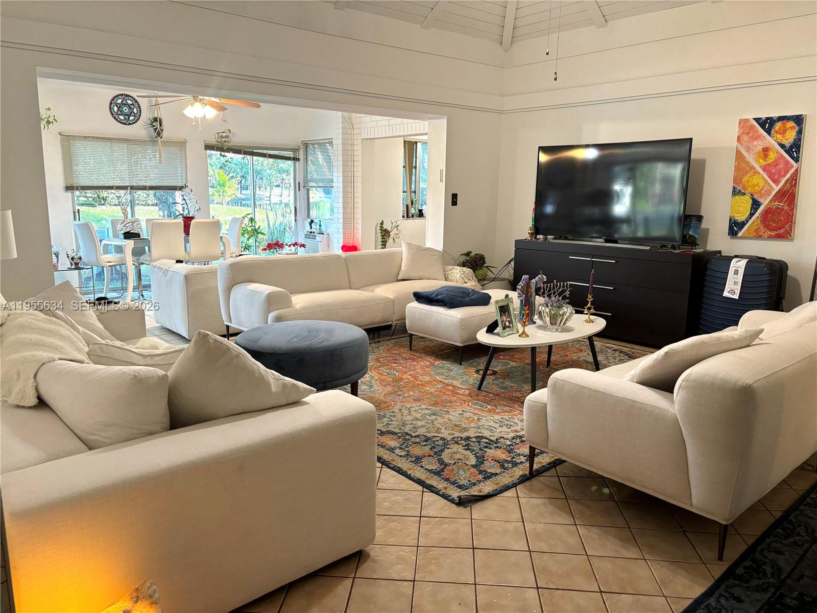 5700 White Hickory Circle Tamarac, FL 33319 - Photo 3 of 18 a living room with furniture and a flat screen tv