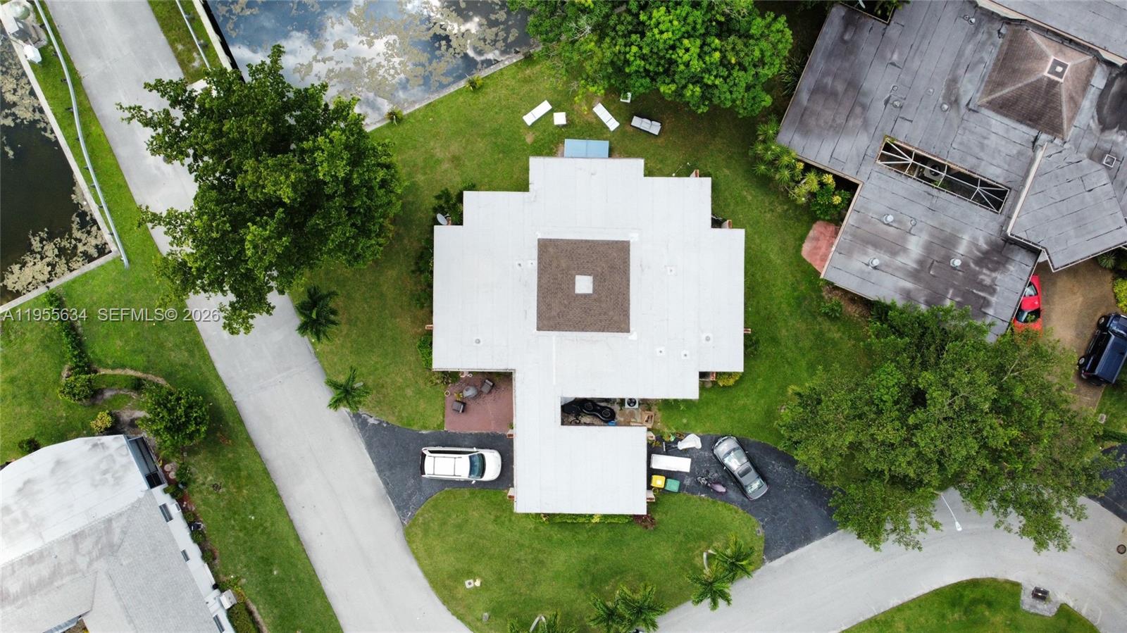 5700 White Hickory Circle Tamarac, FL 33319 - Photo 5 of 18 an aerial view of a house with a garden and trees