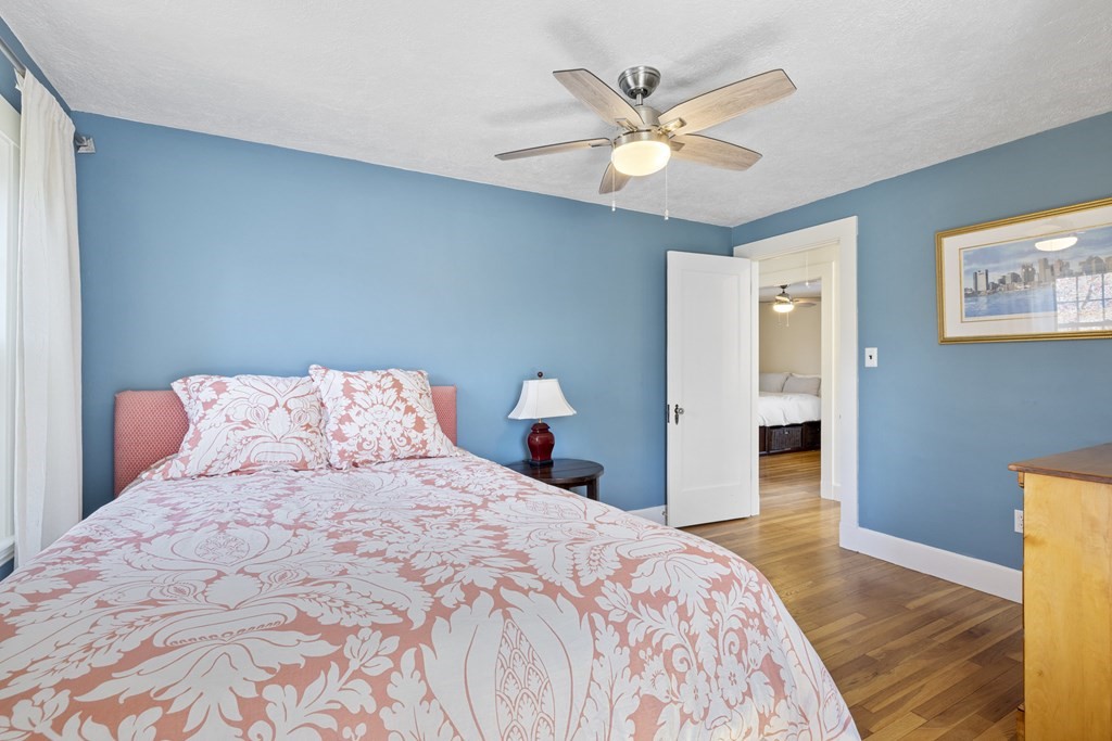 15 Pickwick Road Marblehead, MA 01945 - Photo 19 of 30 a bedroom with a large bed and a chandelier