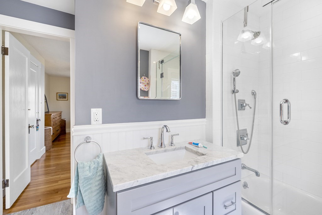 15 Pickwick Road Marblehead, MA 01945 - Photo 21 of 30 a en suite bathroom with a granite countertop sink a mirror and shower