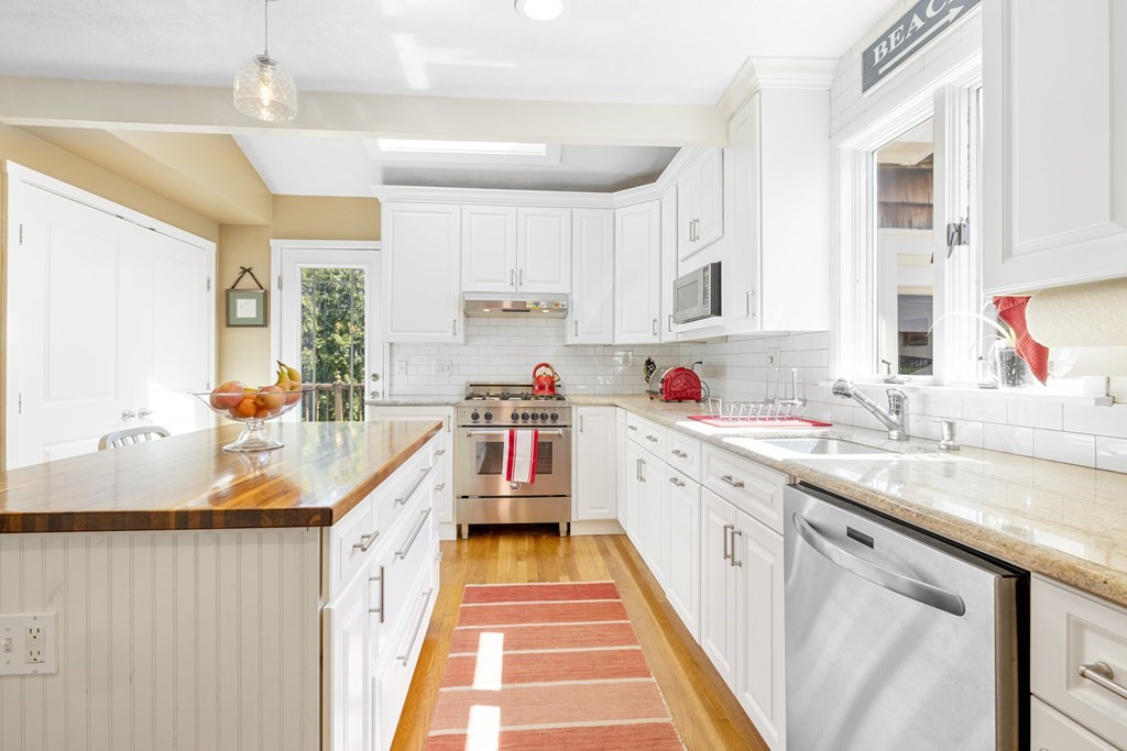 15 Pickwick Road Marblehead, MA 01945 - Photo 9 of 30 a open kitchen with stainless steel appliances granite countertop a sink and cabinets