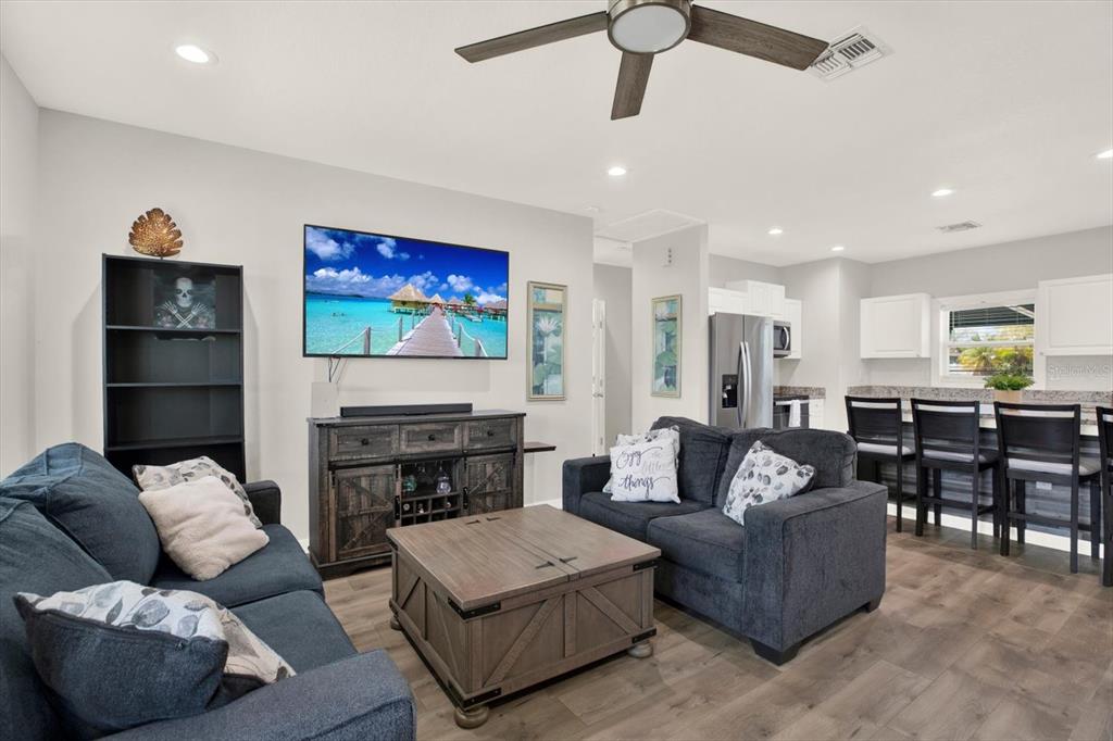 3023 Muir Street Holiday, FL 34691 - Photo 10 of 25 a living room with furniture a fireplace and a chandelier