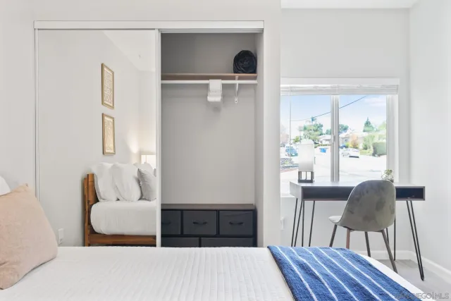 a bedroom with a bed and a chair