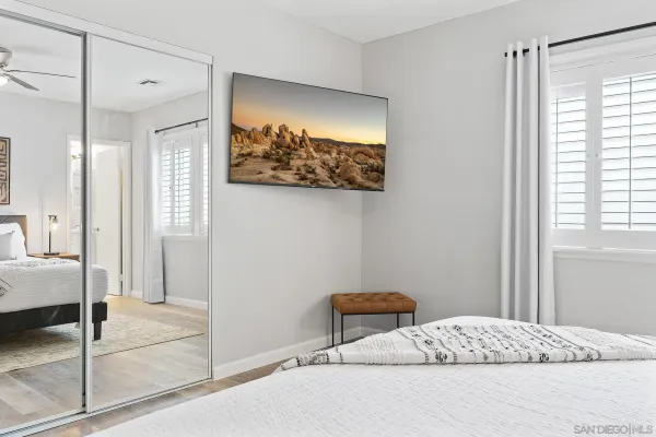 a bedroom with a bed and a painting on the wall