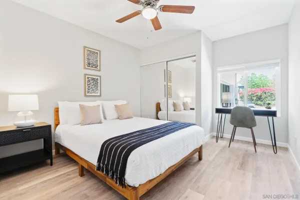 a bedroom with bed and a chandelier