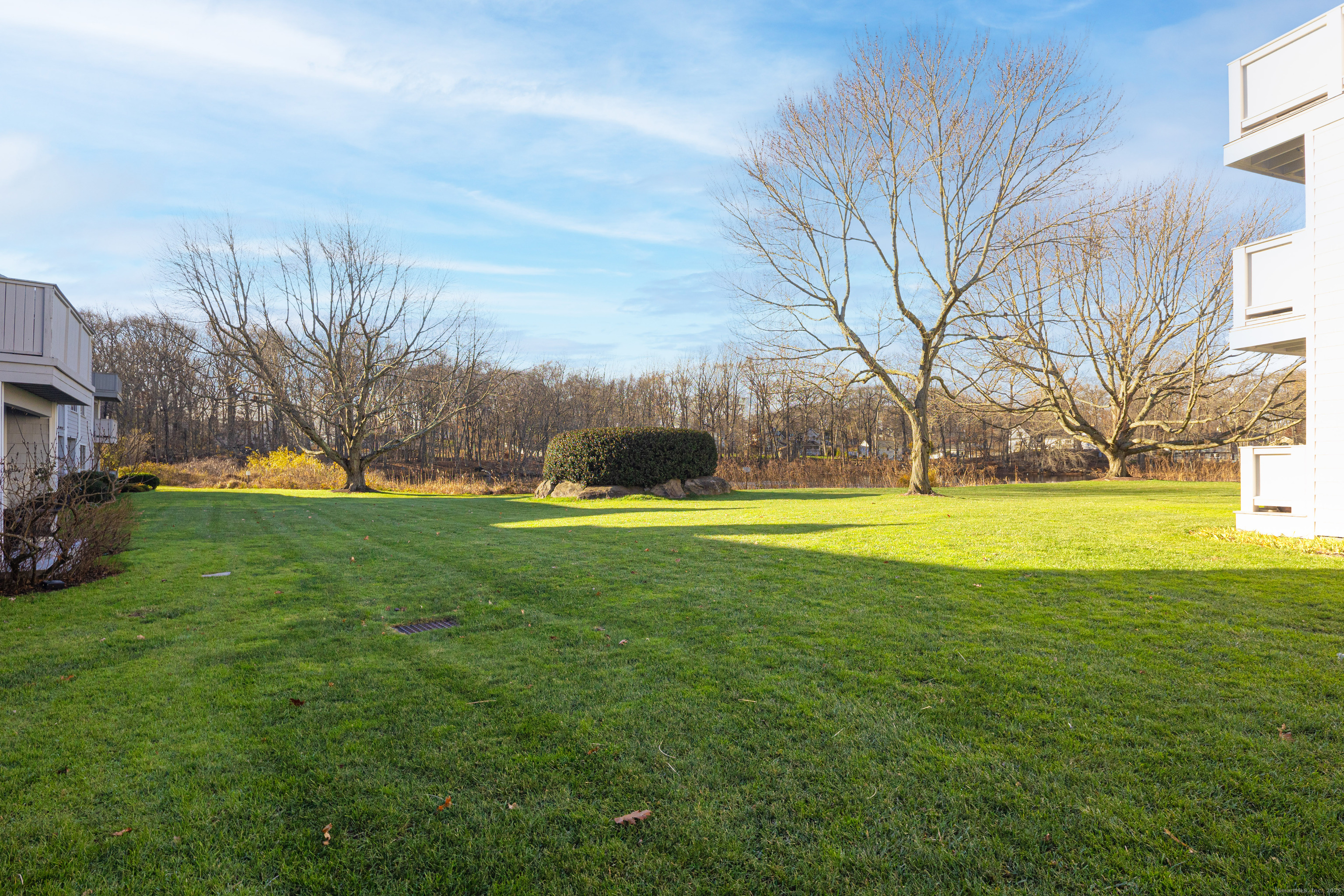 133 Rowayton Woods Drive, Unit 133 Norwalk, CT 06854 - Photo 5 of 40 Flat grassy area in back
