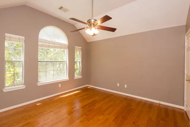 an empty room with a window and a chandelier