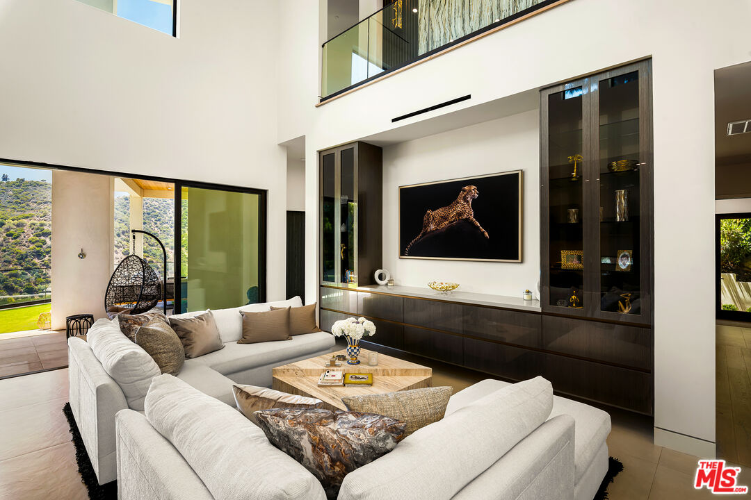1367 Casiano Road Los Angeles, CA 90049 - Photo 6 of 26 a living room with furniture and a flat screen tv