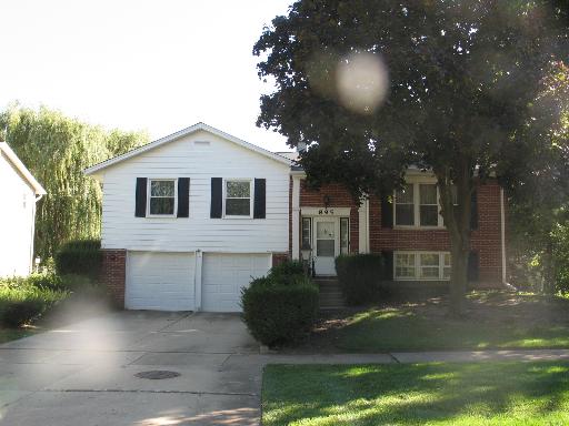 895 Freeman Road Hoffman Estates, IL 60192 - Photo 1 of 1 a front view of a house with a yard and garage