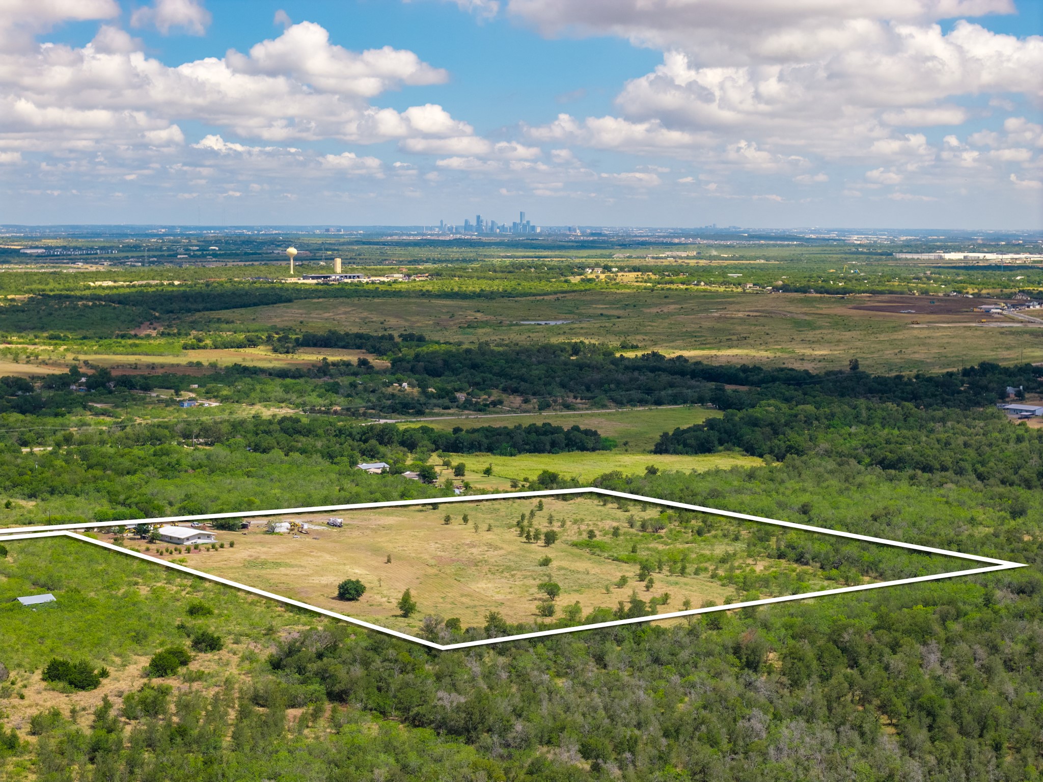 8804 Williamson Road Buda, TX 78610 - Photo 3 of 37 Panoramic views extend toward the distant skyline from this open, tree-lined acreage.
