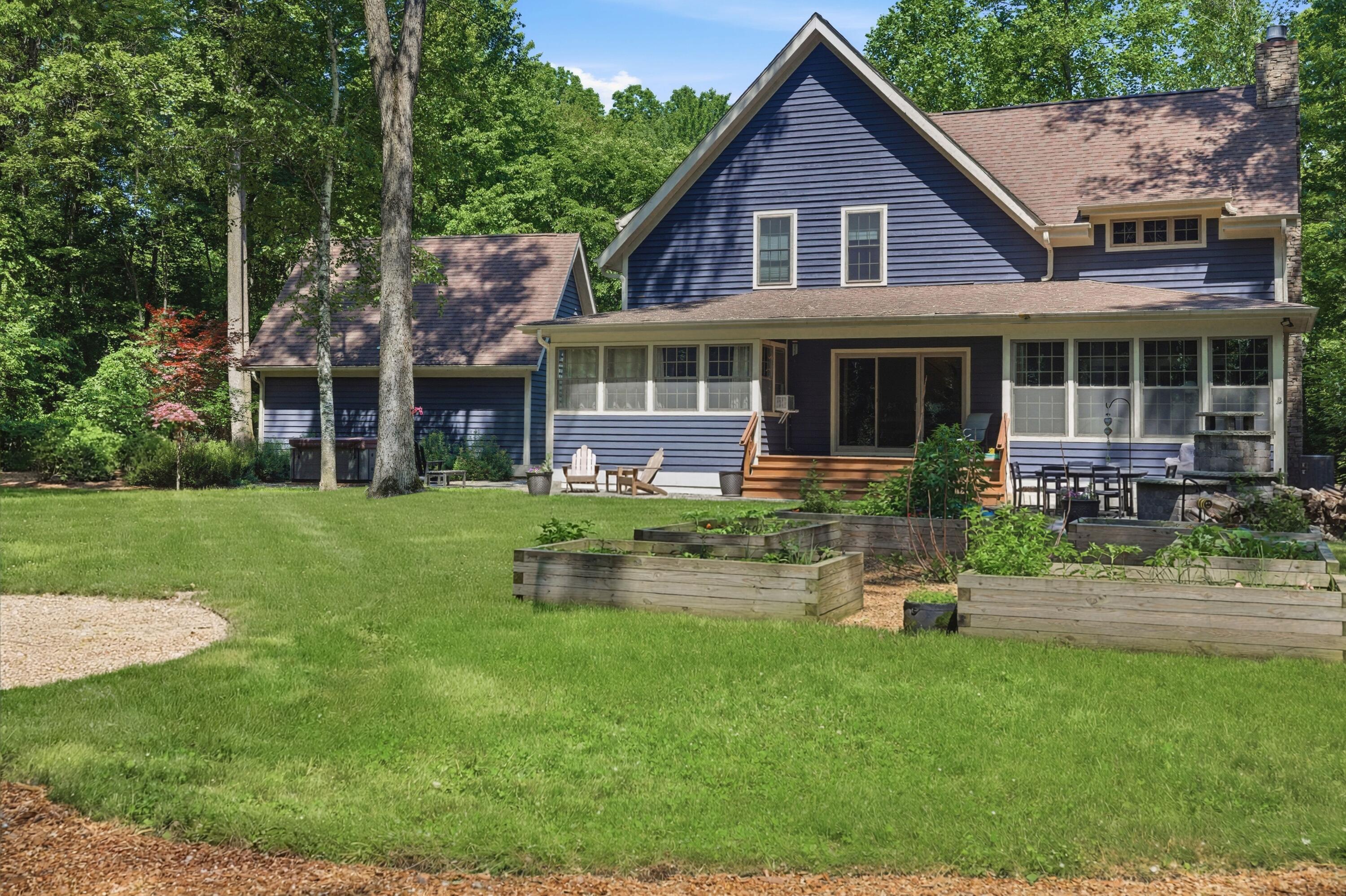 71 Timber Trail Michigan City, IN 46360 - Photo 4 of 27 a front view of a house with a yard table and chairs