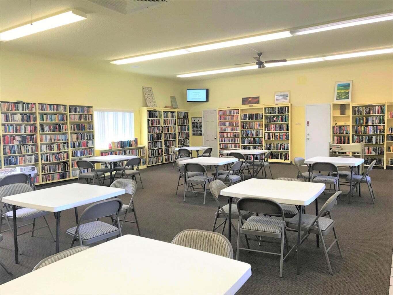 3040 Lake Osborne Drive, Unit 108 Lake Worth Beach, FL 33461 - Photo 23 of 27 a view of a dining room with furniture and chandelier