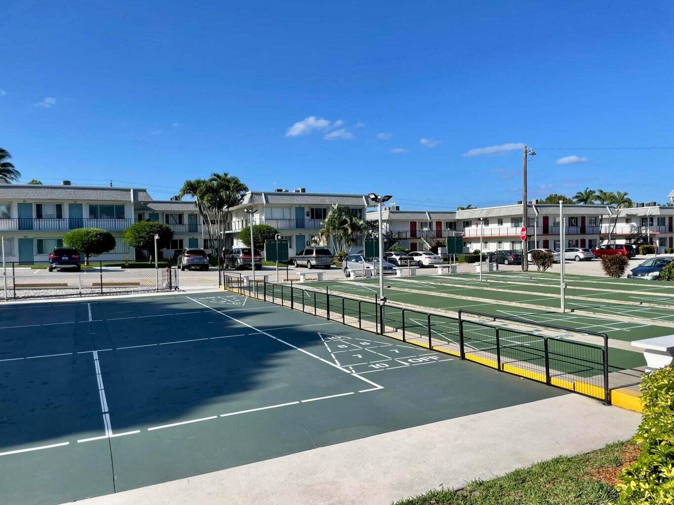 3040 Lake Osborne Drive, Unit 108 Lake Worth Beach, FL 33461 - Photo 24 of 27 a view of an outdoor space and tennis court