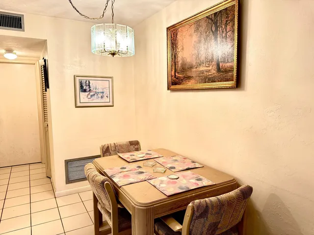 a view of a dining area with furniture and chandelier