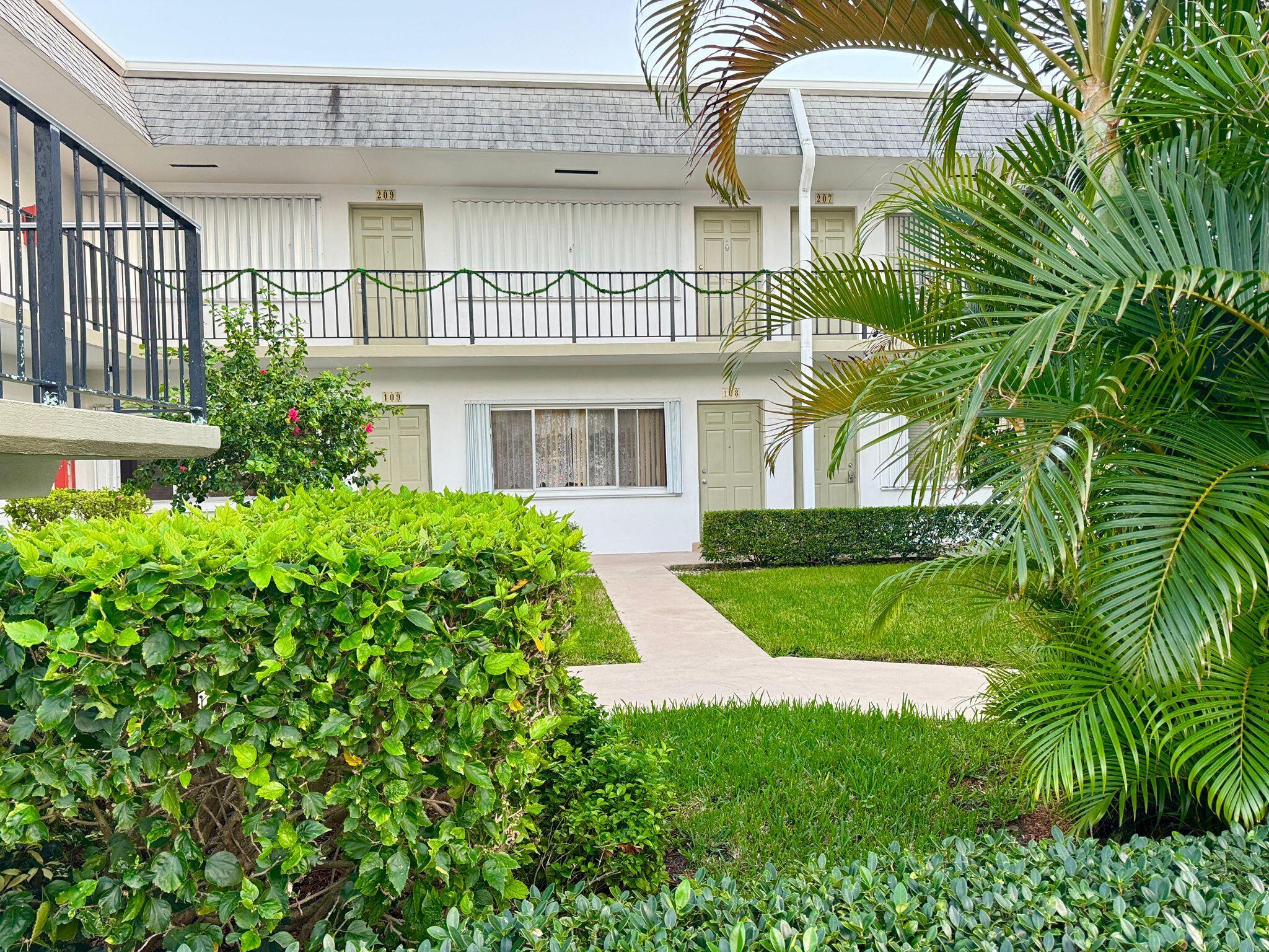 3040 Lake Osborne Drive, Unit 108 Lake Worth Beach, FL 33461 - Photo 10 of 27 a view of a house with a yard