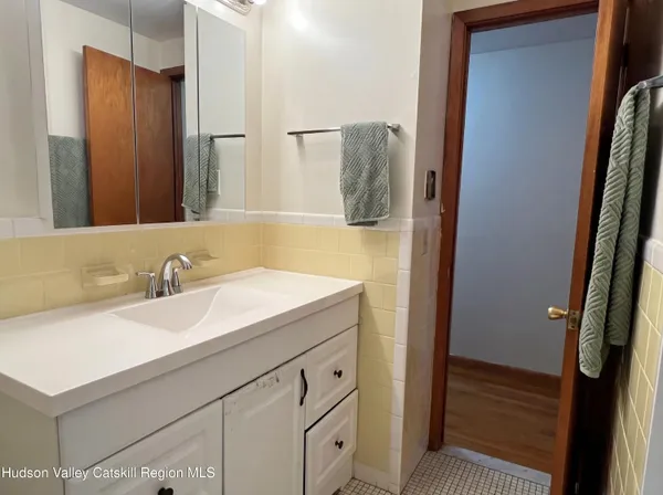 a bathroom with a sink and a mirror