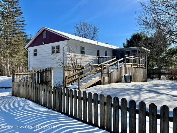 a side view of a house with wooden deck