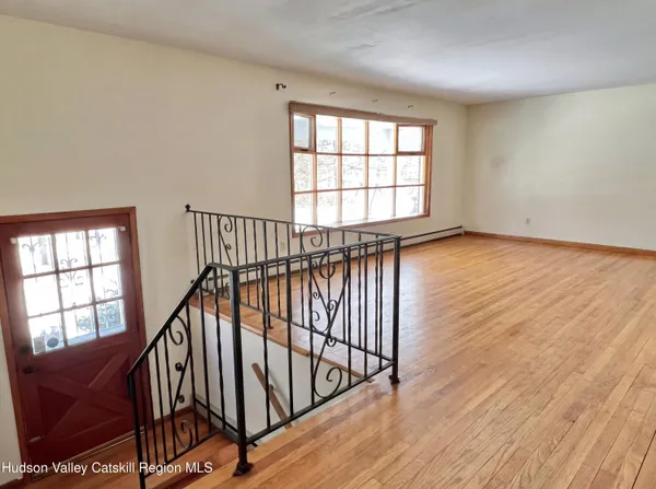a view of an entryway with wooden floor