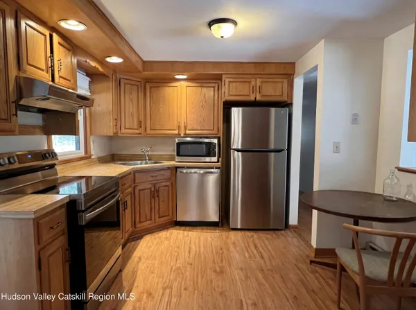 a kitchen with granite countertop a refrigerator stove and sink