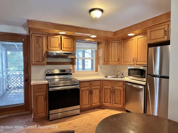 a kitchen with stainless steel appliances granite countertop a stove a refrigerator and a sink