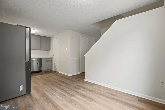 a view of a kitchen with a sink and a refrigerator