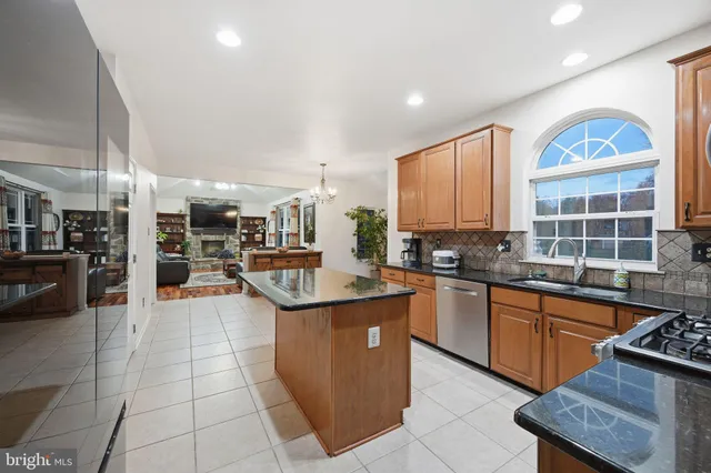 a kitchen with stainless steel appliances granite countertop a sink counter space cabinets and a window