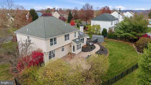 an aerial view of a house with swimming pool and garden