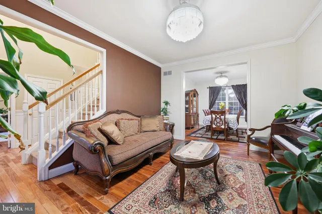 a living room with furniture a rug and a painting on the wall