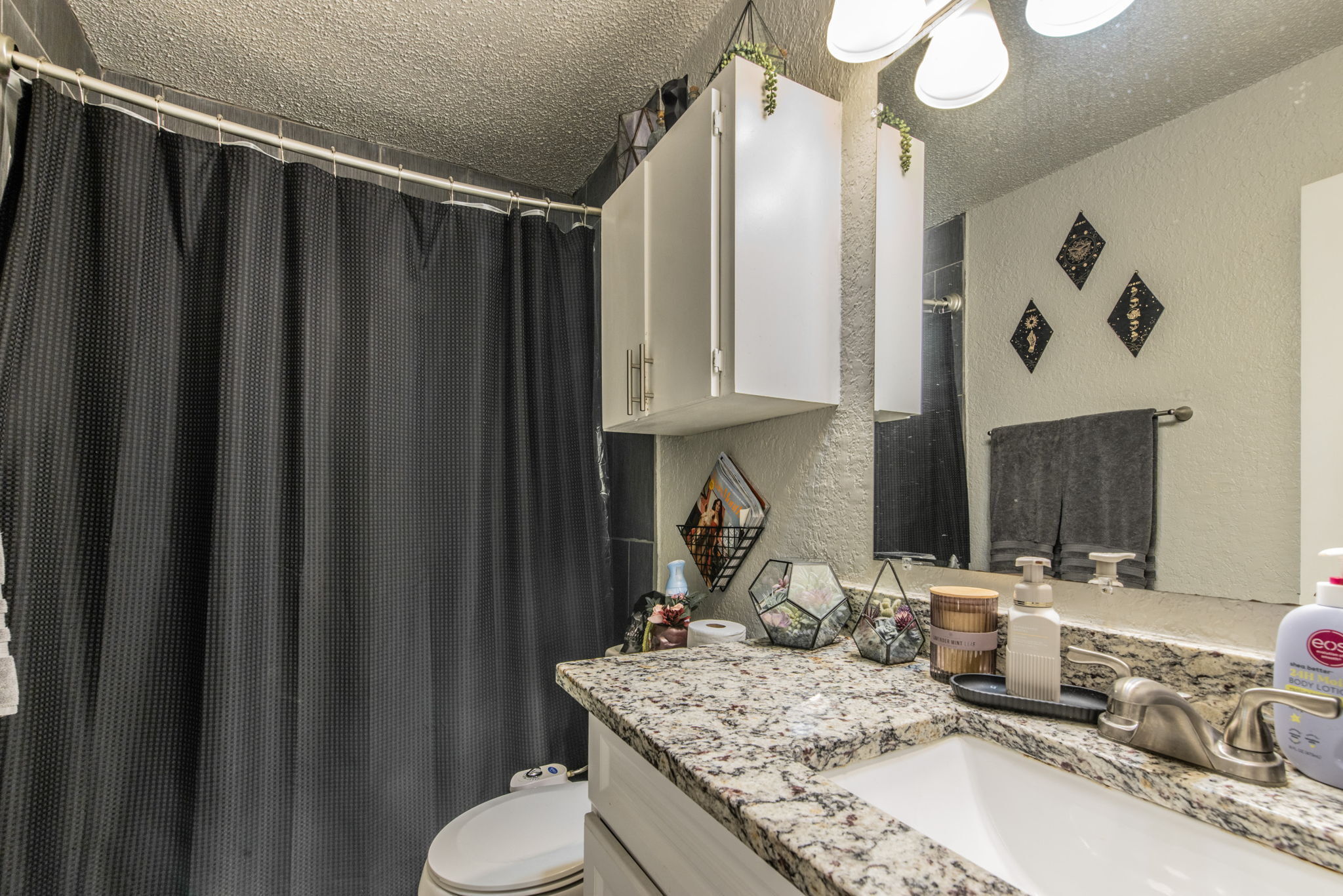1008 Milford Way Austin, TX 78745 - Photo 15 of 40 Vanity featuring a stone-look countertop, integrated sink, and brushed nickel faucet